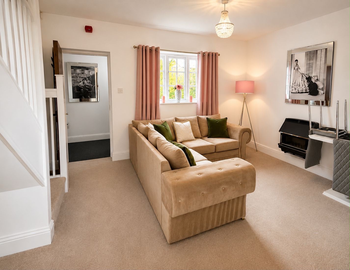 The sitting room downstairs, with a corner sofa, a mirror and the staircase